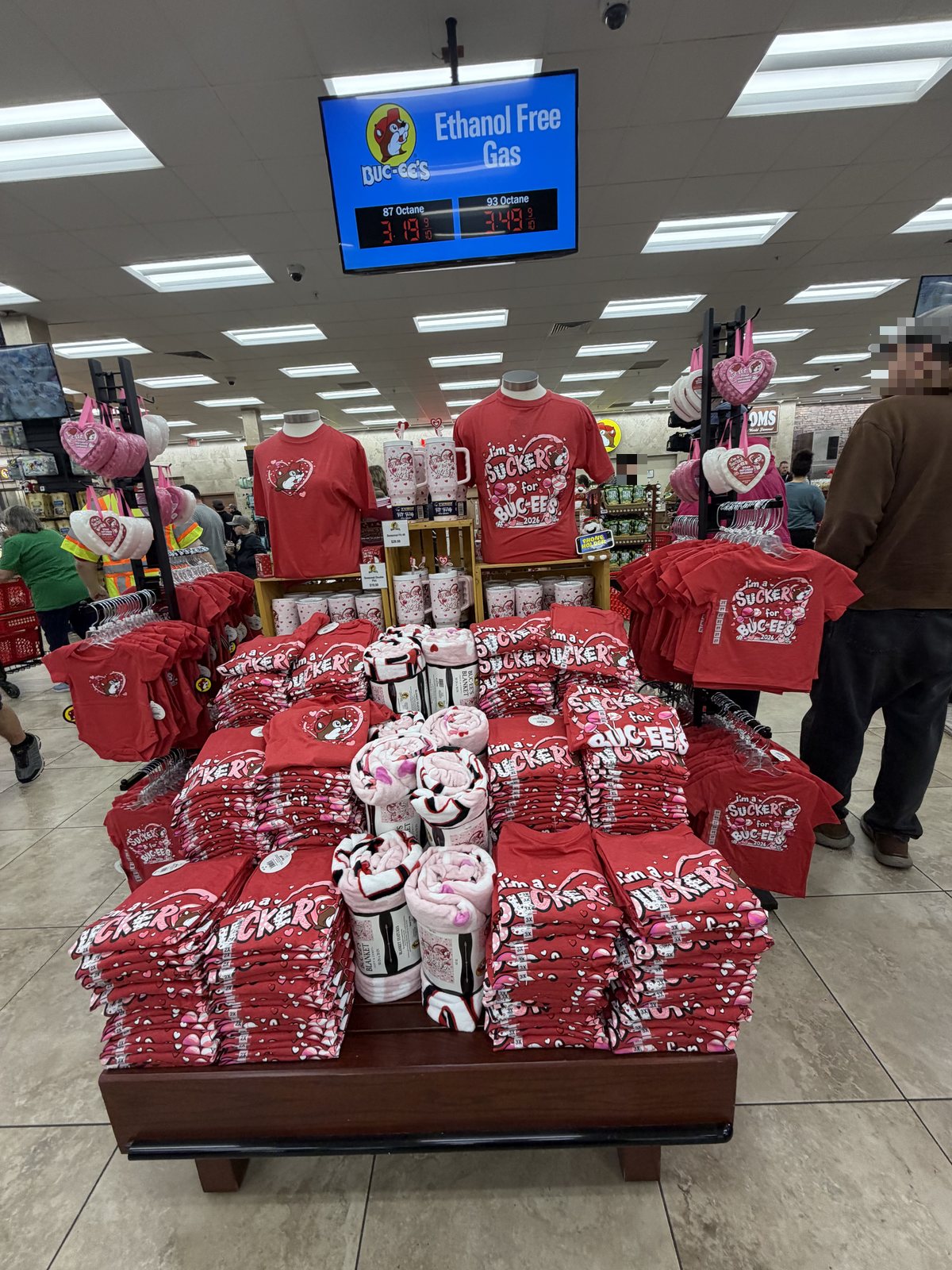Merchandise displays and the fuel price board inside Buc-ee's
